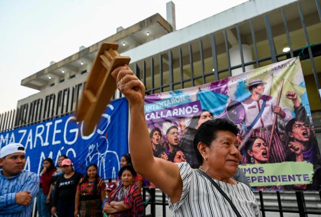 A woman attends a rally to celebrate the end of the term of Attorney General Consuelo Porras on the outskirts of the Public Ministry headquarters in Guatemala City on May 16, 2026. The Attorney General of Guatemala, Consuelo Porras, sanctioned by 40 countries and considered the most powerful woman in the country, is leaving office after eight years, which nevertheless does not dispel the shadow of corruption over the justice system. (Photo by Johan ORDONEZ / AFP)