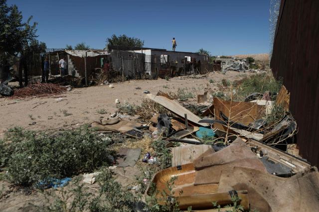 Municipal workers demolish unauthorized dwellings at the Mexico-US border wall in Puerto Anapra neighborhood, Ciudad Juarez, Chihuahua state, Mexico on May 16, 2026. (Photo by Herika Martinez / AFP)