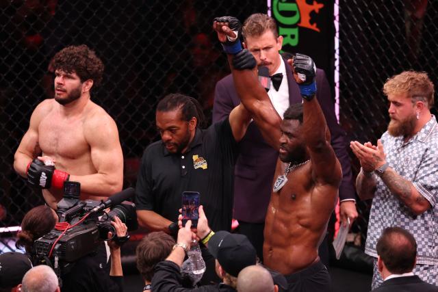 Cameroonian-French mixed martial arts fighter Francis Ngannou (C) celebrates after knocking out Brazilian mixed martial arts fighter Philipe Lins (L) during their heavyweight bout at MVP MMA 1 at the Intuit Dome in Inglewood, California, on May 16, 2026. (Photo by Patrick T. Fallon / AFP)