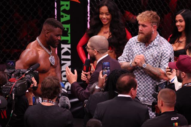 US boxer and influencer Jake Paul (R) looks on as Cameroonian-French mixed martial arts fighter Francis Ngannou (L) is interviewed after knocking out Brazilian mixed martial arts fighter Philipe Lins during their heavyweight bout at MVP MMA 1 at the Intuit Dome in Inglewood, California, on May 16, 2026. (Photo by Patrick T. Fallon / AFP)