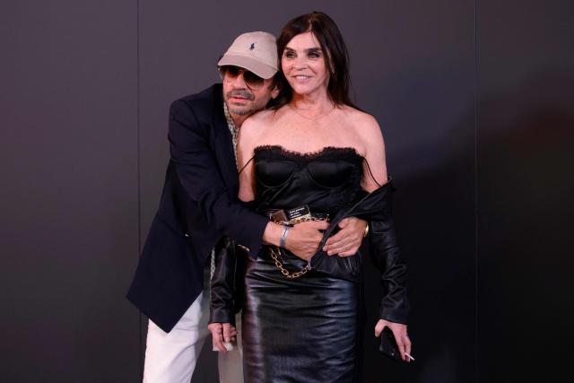French fashion designer Carine Roitfeld (R) attends the Gucci Cruise 2027 collection fashion show at Times Square in New York on May 16, 2026. (Photo by Leonardo MUNOZ / AFP)