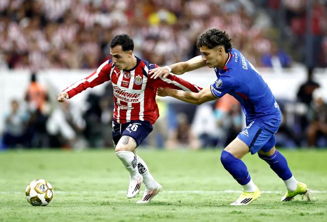 Guadalajara's forward #26 Hugo Camberos and Cruz Azul's defender #05 Jesus Orozco fight for the ball during the Liga MX Clausura semifinal second-leg football match between Guadalajara and Cruz Azul at Jalisco stadium in Guadalajara, Jalisco state, Mexico on May 16, 2026. (Photo by Ulises Ruiz / AFP)