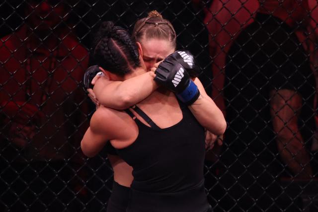 US Mixed Martial Arts (MMA) fighter Ronda Rousey hugs Gina Carano after defeating her during their Featherweight Bout at the Intuit Dome in Inglewood, California, on May 16, 2026. (Photo by Patrick T. Fallon / AFP)