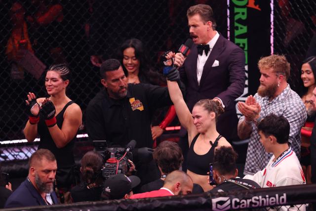US Mixed Martial Arts (MMA) fighter Ronda Rousey celebrates after defeating Gina Carano during their Featherweight Bout at the Intuit Dome in Inglewood, California, on May 16, 2026. (Photo by Patrick T. Fallon / AFP)