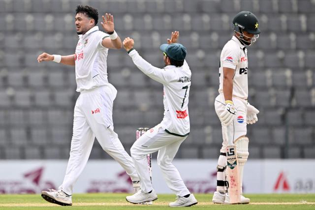 Bangladesh’s Taskin Ahmed (L) celebrates with Mominul Haque (C) after taking the wicket of Pakistan’s Abdullah Fazal during the second day of the second Test cricket match between Bangladesh and Pakistan at the Sylhet International Cricket Stadium in Sylhet on May 17, 2026. (Photo by Munir UZ ZAMAN / AFP)