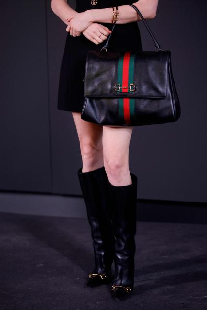 US actress Molly Gordon's purse and shoes are seen as she attends the Gucci Cruise 2027 collection fashion show at Times Square in New York on May 16, 2026. (Photo by Leonardo MUNOZ / AFP)