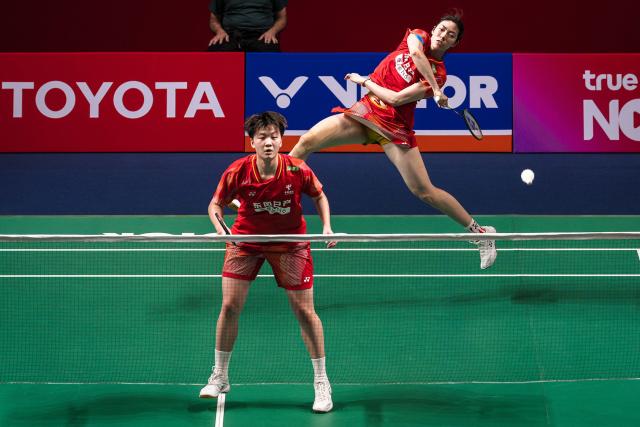 China's Bao Lijing (R) and China's Cao Zihan (L) play a shot against Japan's Rin Iwanaga and Japan's Kie Nakanishi during their women's doubles final match at the Thailand Open badminton tournament in Bangkok on May 17, 2026. (Photo by chanakarn LAOSARAKHAM / AFP)
