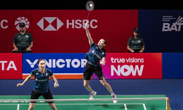 Japan's Rin Iwanaga (R) and Japan's Kie Nakanishi (L) play a shot against China's Bao Lijing and China's Cao Zihan during their women's doubles final match at the Thailand Open badminton tournament in Bangkok on May 17, 2026. (Photo by chanakarn LAOSARAKHAM / AFP)