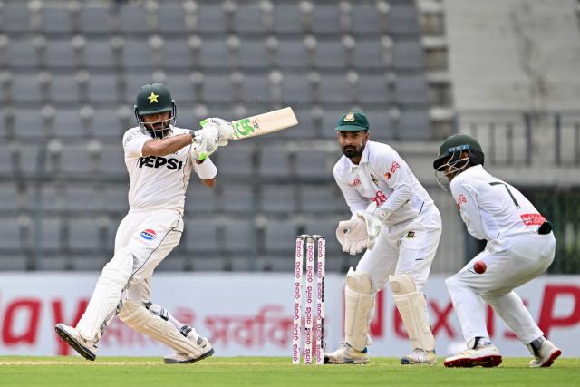 Pakistan’s Babar Azam (L) plays a shot as Bangladesh’s wicketkeeper Litton Das (C) and Mominul Haque field the ball during the second day of the second Test cricket match between Bangladesh and Pakistan at the Sylhet International Cricket Stadium in Sylhet on May 17, 2026. (Photo by Munir UZ ZAMAN / AFP)