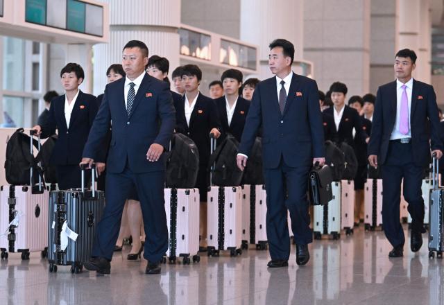 North Korea's Naegohyang Women's FC players and staff arrive at Incheon International Airport in Incheon on May 17, 2026, ahead of the Women's Asian Champions League semi-final football match against South Korea's Suwon FC Women. A North Korean women's football team arrived in South Korea on May 17, marking the first visit by a sports team from the isolated country to its southern neighbour in eight years, to play in the Asian Champions League semi-finals. (Photo by Jung Yeon-je / AFP)