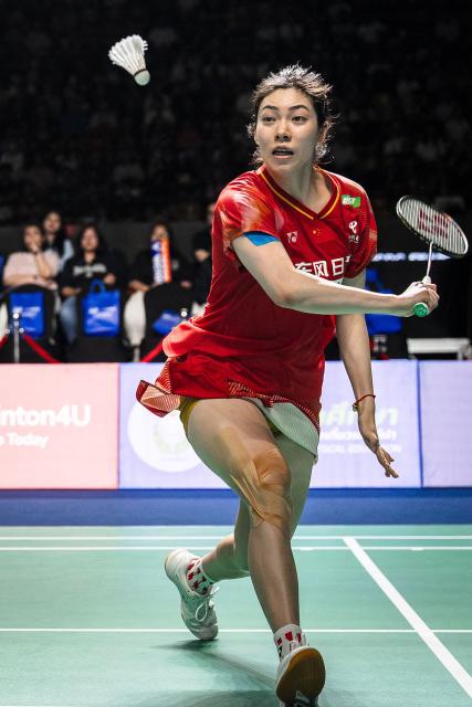 China's Bao Lijing plays a shot against Japan's Kie Nakanishi and Japan's Rin Iwanaga during her women's doubles final match with China's Cao Zihan (unseen) at the Thailand Open badminton tournament in Bangkok on May 17, 2026. (Photo by chanakarn LAOSARAKHAM / AFP)