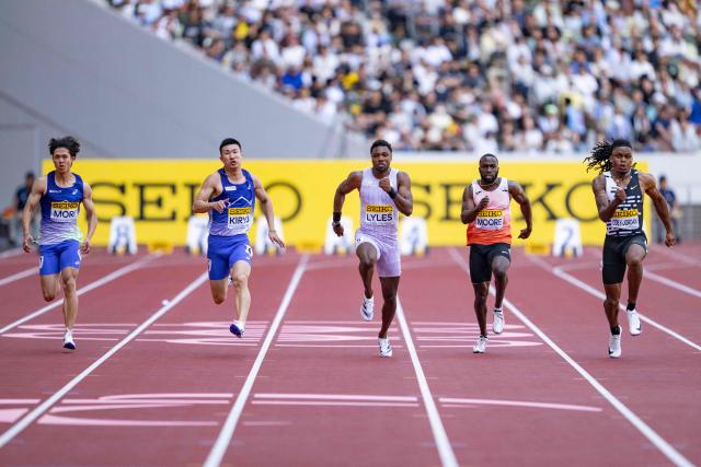 Athletes, including Japan's Yoshihide Kiryu, US' Noah Lyles and US' Marcellus Moore, compete in the men's 100m final during the Golden Grand Prix athletics at the National Stadium in Tokyo on May 17, 2026. (Photo by Yuichi YAMAZAKI / AFP)