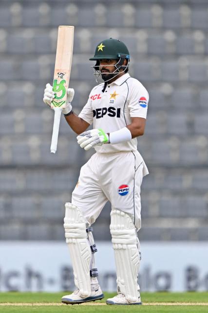 Pakistan’s Babar Azam celebrates after scoring a half-century (50 runs) during the second day of the second Test cricket match between Bangladesh and Pakistan at the Sylhet International Cricket Stadium in Sylhet on May 17, 2026. (Photo by Munir UZ ZAMAN / AFP)