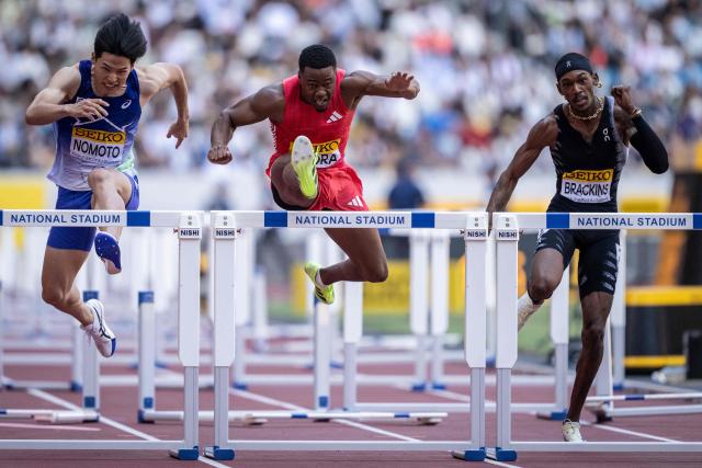 (L-R) Japan's Shusei Nomoto, Britain's Tade Ojora and US' Johnny Brackins compete in the men's 110m hurdles during the Golden Grand Prix athletics at the National Stadium in Tokyo on May 17, 2026. (Photo by Yuichi YAMAZAKI / AFP)