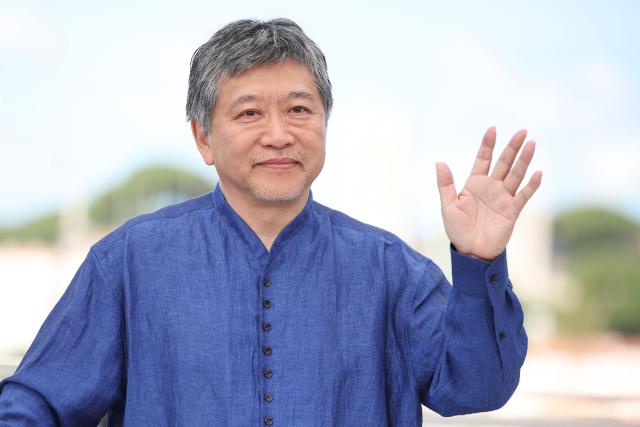 Japanese director and screenwriter Hirokazu Kore-eda waves as he poses during a photocall of the film "Sheep in The Box" at the 79th edition of the Cannes Film Festival in Cannes, southern France on May 17, 2026. (Photo by Valery HACHE / AFP)