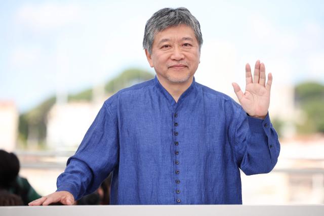Japanese director and screenwriter Hirokazu Kore-eda waves as he poses during a photocall of the film "Sheep in The Box" at the 79th edition of the Cannes Film Festival in Cannes, southern France on May 17, 2026. (Photo by Valery HACHE / AFP)