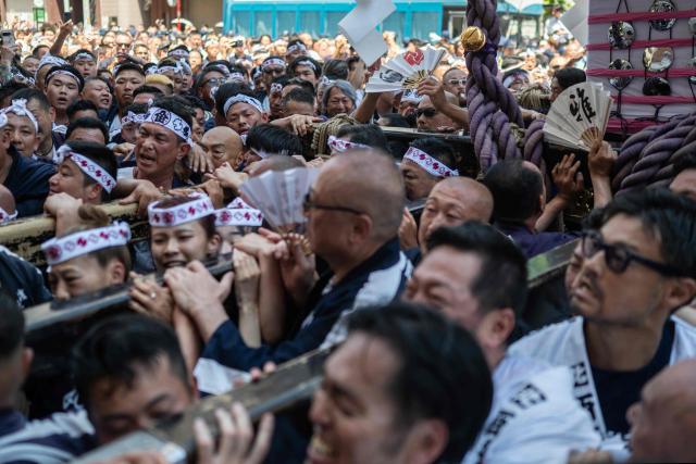 People carry a portable shrine during the Sanja Matsuri festival in Tokyo on May 17, 2026, one of Tokyo’s largest Shinto celebrations. (Photo by Andrew CABALLERO-REYNOLDS / AFP)