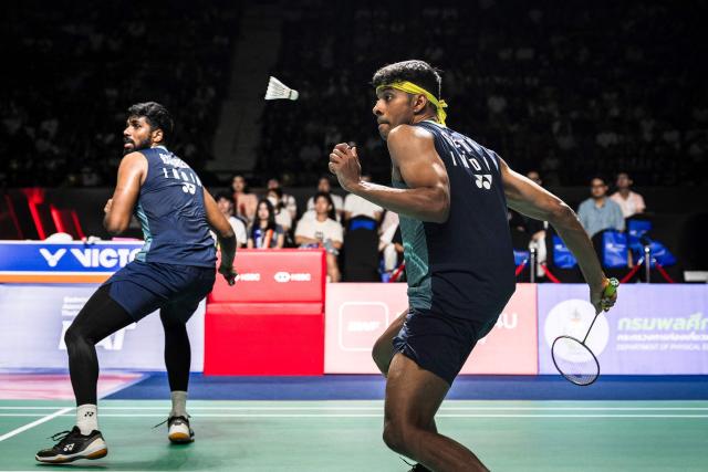 India's Chirag Shetty and Satwiksairaj Rankireddy play a point against Indonesia’s Leo Rolly Carnando and Daniel Marthin during their men's doubles final match at the Thailand Open badminton tournament in Bangkok on May 17, 2026. (Photo by chanakarn LAOSARAKHAM / AFP)