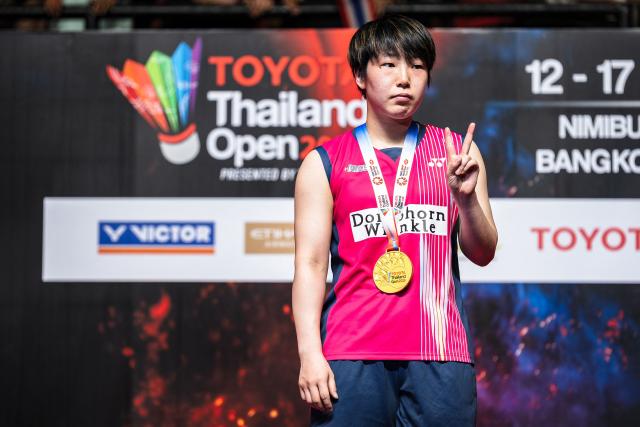 Japan's Akane Yamaguchi poses with her medal on the podium after winning against China's Chen Yufei in their women's singles final match at the Thailand Open badminton tournament in Bangkok on May 17, 2026. (Photo by chanakarn LAOSARAKHAM / AFP)