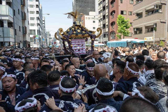 People carry a portable shrine during the Sanja Matsuri festival in Tokyo on May 17, 2026, one of Tokyo’s largest Shinto celebrations. (Photo by Andrew CABALLERO-REYNOLDS / AFP)