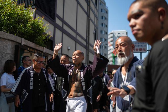 Participants with traditional full-body irezumi tattoos prepare to march with a portable shrine during final day of the Sanja Matsuri festival in Tokyo on May 17, 2026, one of Tokyo’s largest Shinto celebrations. (Photo by Andrew CABALLERO-REYNOLDS / AFP)