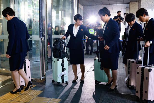North Korea's Naegohyang Women's FC players arrive at a hotel in Suwon on May 17, 2026, ahead of the Women's Asian Champions League semi-final football match against South Korea's Suwon FC Women. A North Korean women's football team landed in South Korea on May 17, marking the first visit by a sports team from the isolated country to its southern neighbour in eight years, to play in the Asian Champions League semi-finals. (Photo by Shin Yong-ju / AFP)