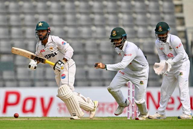 Pakistan’s Sajid Khan (L) reacts after playing a shot as Bangladesh’s Mominul Haque (C) and wicketkeeper Litton Das field the ball during the second day of the second Test cricket match between Bangladesh and Pakistan at the Sylhet International Cricket Stadium in Sylhet on May 17, 2026. (Photo by Munir UZ ZAMAN / AFP)