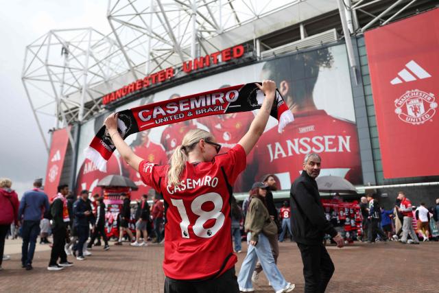 A fan of Manchester United's Brazilian midfielder Casemiro poses for a picture outside the ground ahead of the English Premier League football match between Manchester United and Nottingham Forest at Old Trafford in Manchester, north west England, on May 17, 2026. (Photo by Darren Staples / AFP)