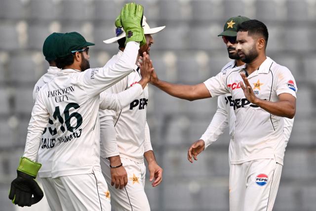 Pakistan’s Khurram Shahzad (R) celebrates with teammates after taking the wicket of Bangladesh’s Tanzid Hasan during the second day of the second Test cricket match between Bangladesh and Pakistan at the Sylhet International Cricket Stadium in Sylhet on May 17, 2026. (Photo by Munir UZ ZAMAN / AFP)