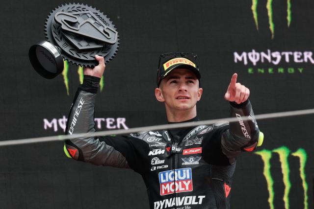 Third placed Team Liqui Moly Husqvarna Intact GP's David Munoz celebrates on the podium after the Moto3 race of the 2026 Catalunya Moto Grand Prix at the Catalunya racetrack in Montmelo, near Barcelona, on May 17, 2026. (Photo by Lluis GENE / AFP)
