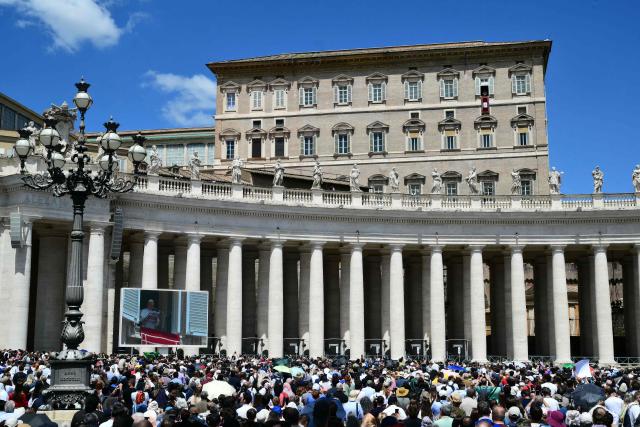 Pope Leo XIV addresses the crowd from the window of the apostolic palace overlooking St. Peter's square during the Regina Caeli prayer in The Vatican on May 17, 2026. (Photo by Stefano RELLANDINI / AFP)
