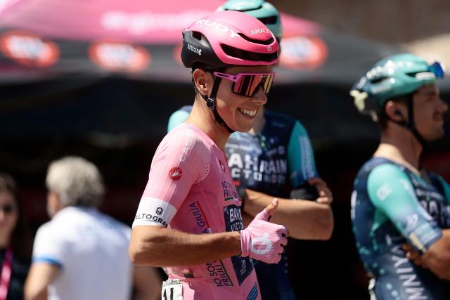Bahrain - Victorious Portuguese rider Afonso Eulalio, wearing the overall leader's pink jersey (Maglia Rosa), gestures before the 9th stage of the Giro d'Italia 2026 - Tour of Italy cycling race between Cervia and Corno alle Scale, central Italy on May 17, 2026. (Photo by Luca Bettini / AFP)