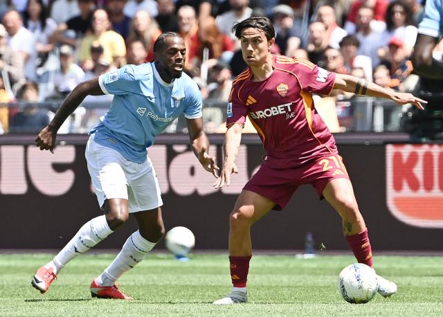 Roma's Argentine forward #21 Paulo Dybala controls the ball next to Lazio's Portuguese defender #17 Nuno Tavares during the Italian Serie A football match between Roma and Lazio at Olympic stadium in Rome on May 17, 2026. (Photo by Isabella BONOTTO / AFP)