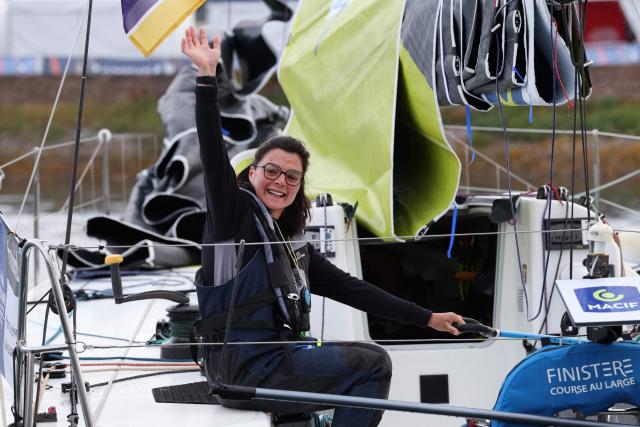 French skipper Chloe le Bars waves from her boat "Skipper Macif 2026 before the start of the Solitaire du Figaro, a single-handed multi-stage sailing race created in 1970 by Jean-Louis Guillemard and Jean-Michel Barrault, in Perros-Guirrec, western France,  May 17, 2026. (Photo by Fred TANNEAU / AFP)