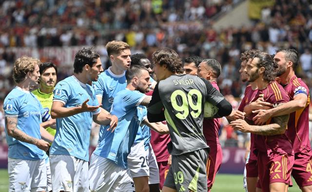 Roma's Serbian goalkeeper #99 Mile Svilar argues with Lazio's Italian forward #22 Matteo Cancellieri (2nd L) during the Italian Serie A football match between Roma and Lazio at Olympic stadium in Rome on May 17, 2026. (Photo by Isabella BONOTTO / AFP)