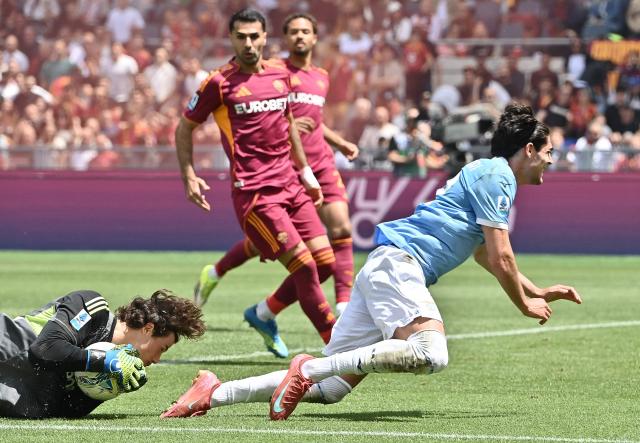 Roma's Serbian goalkeeper #99 Mile Svilar catches the ball in front of Lazio's Italian forward #22 Matteo Cancellieri during the Italian Serie A football match between Roma and Lazio at Olympic stadium in Rome on May 17, 2026. (Photo by Isabella BONOTTO / AFP)