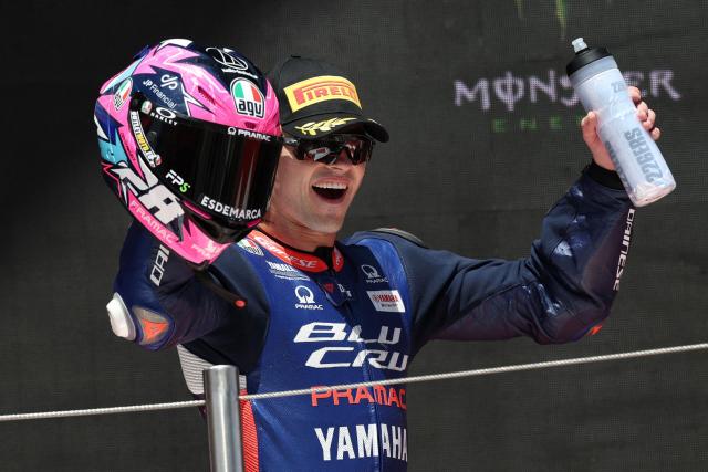 Team Blu Cru Pramac Yamaha Moto2 Team's Izan Guevara celebrates his third place finish on the podium for the Moto2 race of the 2026 Catalunya Moto Grand Prix at the Catalunya racetrack in Montmelo, near Barcelona, on May 17, 2026. (Photo by Lluis GENE / AFP)