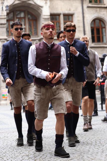 Bayern Munich's German midfielder #45 Aleksandar Pavlovic, Bayern Munich's German midfielder #42 Lennart Karl and Bayern Munich's German midfielder #20 Tom Bischof arrive to celebrate with Bayern Munich's players their 35th Bundesliga title at the City Hall at Marienplatz in Munich, southern Germany, on May 17, 2026. (Photo by Alexandra BEIER / AFP)