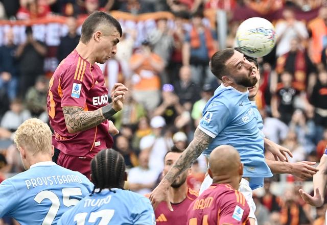 Roma's Italian defender #23 Gianluca Mancini heads the ball and scores his team's second goal during the Italian Serie A football match between Roma and Lazio at Olympic stadium in Rome on May 17, 2026. (Photo by Isabella BONOTTO / AFP)