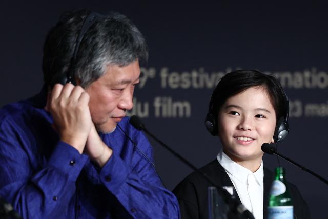 Japanese director and screenwriter Hirokazu Kore-eda and Japanese actor Rimu Kuwaki attend a press conference for the film "Sheep in The Box" at the 79th edition of the Cannes Film Festival in Cannes, southern France on May 17, 2026. (Photo by Ian LANGSDON / AFP)