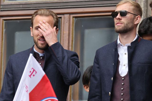 Bayern Munich's English forward #09 Harry Kane gestures next to Bayern Munich's Austrian midfielder #27 Konrad Laimer as Bayern Munich's players celebrate their 35th Bundesliga championship title at the City Hall at Marienplatz in Munich, southern Germany, on May 17, 2026. (Photo by Alexandra BEIER / AFP)