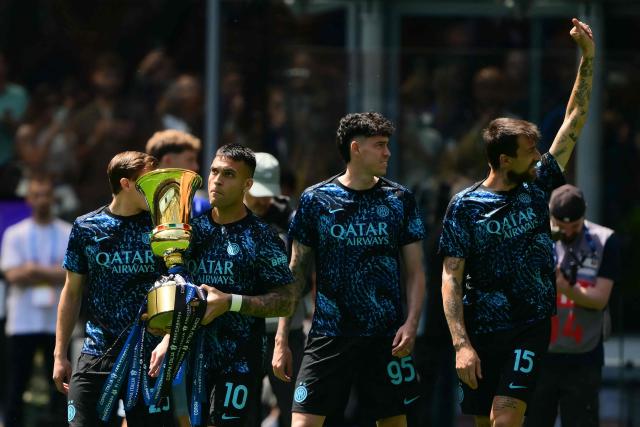 Inter Milan's Argentinian forward #10 Lautaro Martinez holds the Italian Cup as he enters the pitch with teammates before the Italian Serie A football match between Inter Milan and Hellas Verona at San Siro stadium in Milan, on May 17, 2026. Inter Milan won the Italian Cup (Coppa Italia) last week and will celebrate today the 21st Scudetto (Serie A Italian Championship victory) with a parade in the city of Milan. (Photo by Marco BERTORELLO / AFP)