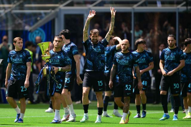 Inter Milan's Argentinian forward #10 Lautaro Martinez holds the Italian Cup as he enters the pitch with teammates before the Italian Serie A football match between Inter Milan and Hellas Verona at San Siro stadium in Milan, on May 17, 2026. Inter Milan won the Italian Cup (Coppa Italia) last week and will celebrate today the 21st Scudetto (Serie A Italian Championship victory) with a parade in the city of Milan. (Photo by Marco BERTORELLO / AFP)