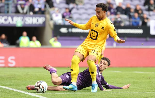 Mechelen's French defender #07 Therence Koudou is tackled by RSC Anderlecht's Belgian forward #83 Tristan Degreef during the Belgian "Pro League" Champions' play-off (day 8 out of 10) football match between RSC Anderlecht and KV Mechelen at the Stade Constant Vanden Stock, in Brussels on May 17, 2026. (Photo by VIRGINIE LEFOUR / BELGA / AFP)
