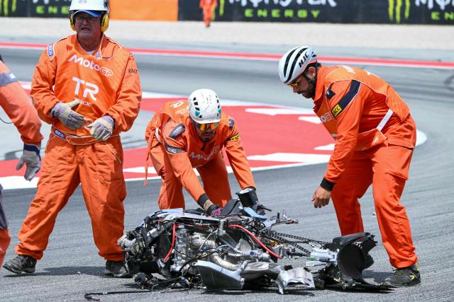 Offiials remove the destroyed motorcycle of Team Gresini Racing MotoGP's Alex Marquez following a crash during the 2026 Catalunya Moto GP Grand Prix at the Catalunya racetrack in Montmelo, near Barcelona, on May 17, 2026. (Photo by JOSE JORDAN / AFP)
