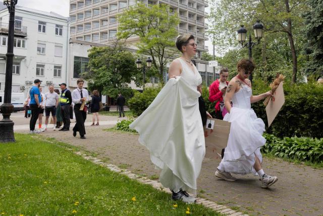 Protesters dressed as brides arrive for a demonstration against the new Civil Code, warning it could restrict the rights of women, children, people with disabilities, and the LGBTQ community by regulating issues such as abortion, early marriage, and alimony in Kyiv on May 17, 2026, amid the Russian invasion of Ukraine. (Photo by Tetiana DZHAFAROVA / AFP)