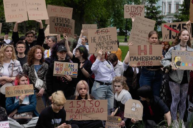 Protesters hold placards during a demonstration against the new Civil Code, warning it could restrict the rights of women, children, people with disabilities, and the LGBTQ community by regulating issues such as abortion, early marriage, and alimony in Kyiv on May 17, 2026, amid the Russian invasion of Ukraine. (Photo by Tetiana DZHAFAROVA / AFP)