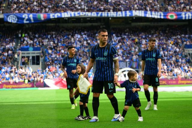 Inter Milan's Argentinian forward #10 Lautaro Martinez walks on the pitch with his children before the Italian Serie A football match between Inter Milan and Hellas Verona at San Siro stadium in Milan, on May 17, 2026. (Photo by Marco BERTORELLO / AFP)