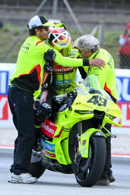 Team Pertamina Enduro VR46 Racing Team's Fabio Di Giannantonio celebrates with Valentino Rossi (L) after the 2026 Catalunya Moto GP Grand Prix at the Catalunya racetrack in Montmelo, near Barcelona, on May 17, 2026. (Photo by JOSE JORDAN / AFP)
