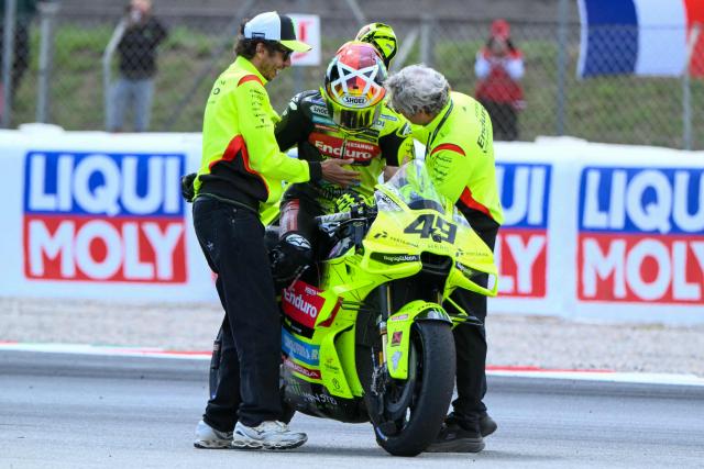 Team Pertamina Enduro VR46 Racing Team's Fabio Di Giannantonio celebrates with Valentino Rossi (L) after the 2026 Catalunya Moto GP Grand Prix at the Catalunya racetrack in Montmelo, near Barcelona, on May 17, 2026. (Photo by JOSE JORDAN / AFP)